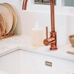 rose gold faucet attached to a modern sink